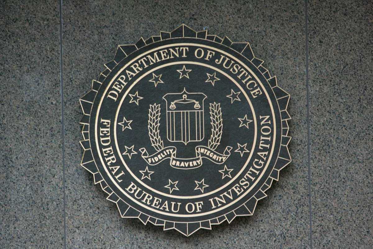 the seal of the department of justice on a wall.