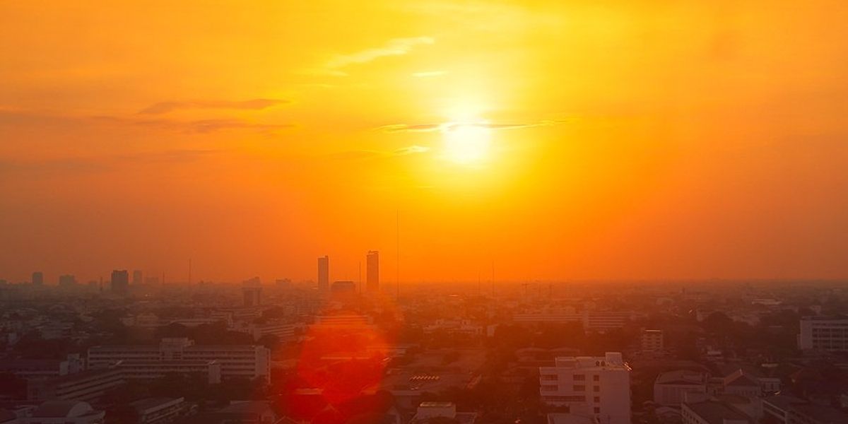 The sun setting over an urban landscape.