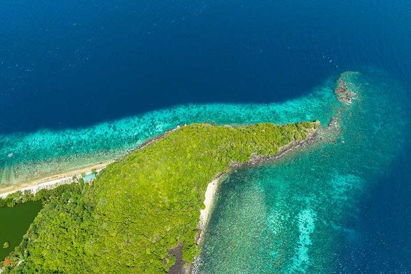 The tip of a spit of land with aqua water surrounding it
