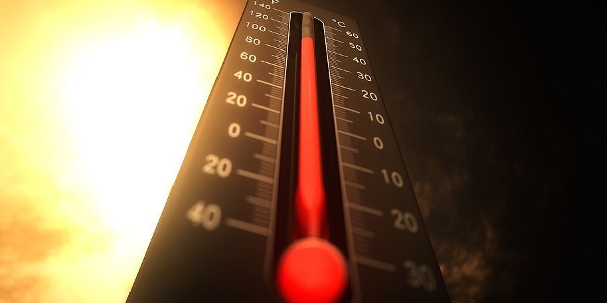 Thermometer with rising temperature and glowing sun in background.