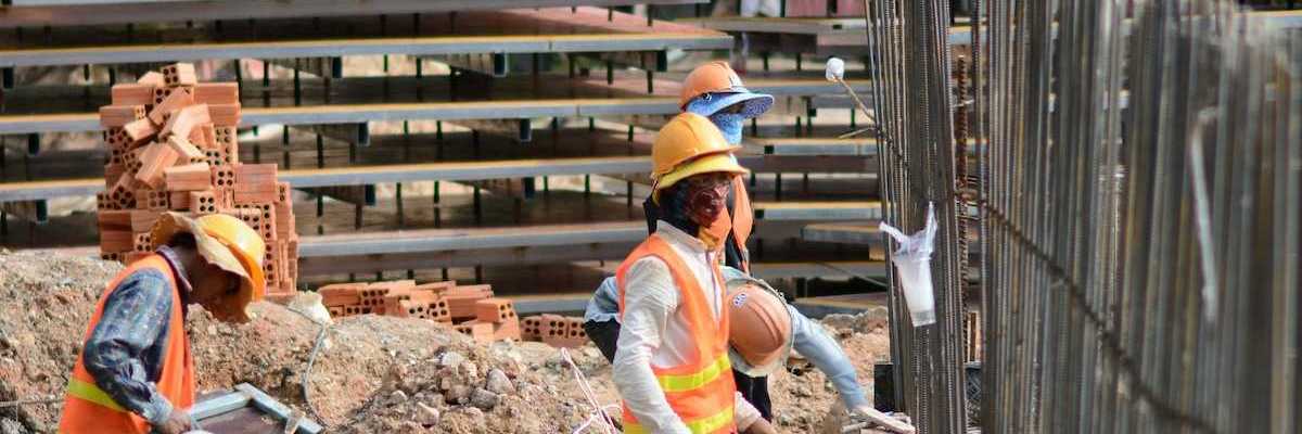 Three construction workers on a job site