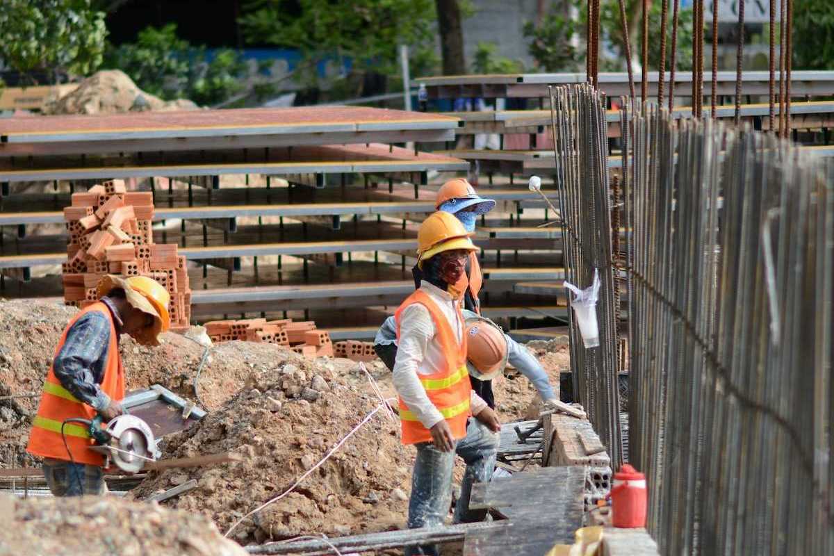 Three construction workers on a job site