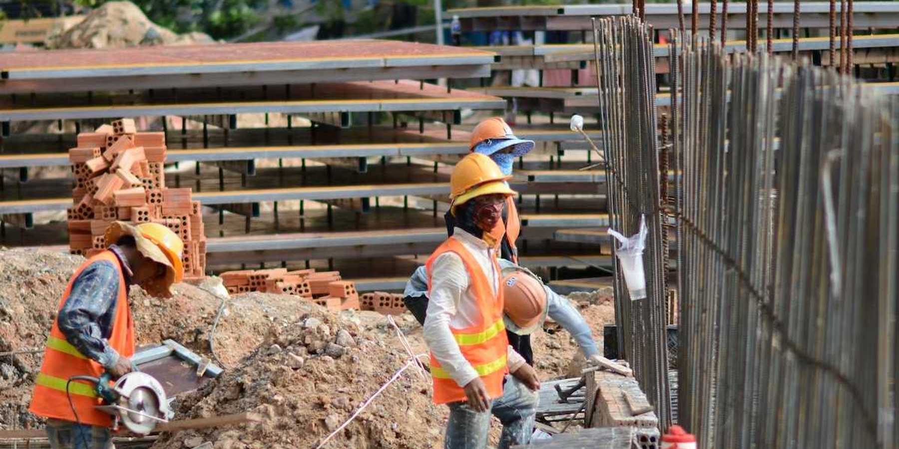 Three construction workers on a job site