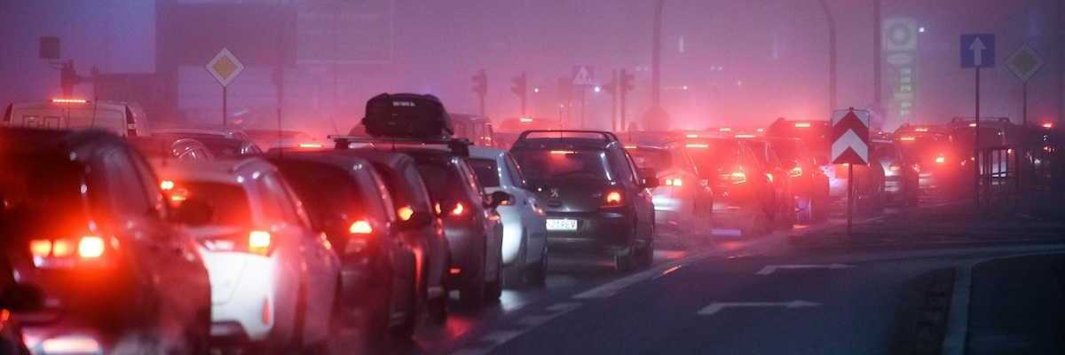 Traffic lined up at stoplight, idling and polluting
