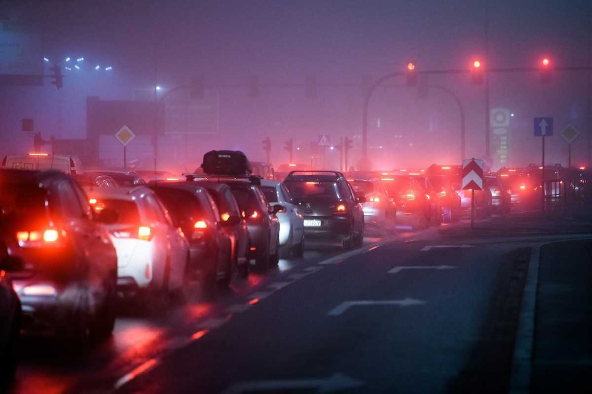 Traffic lined up at stoplight, idling and polluting