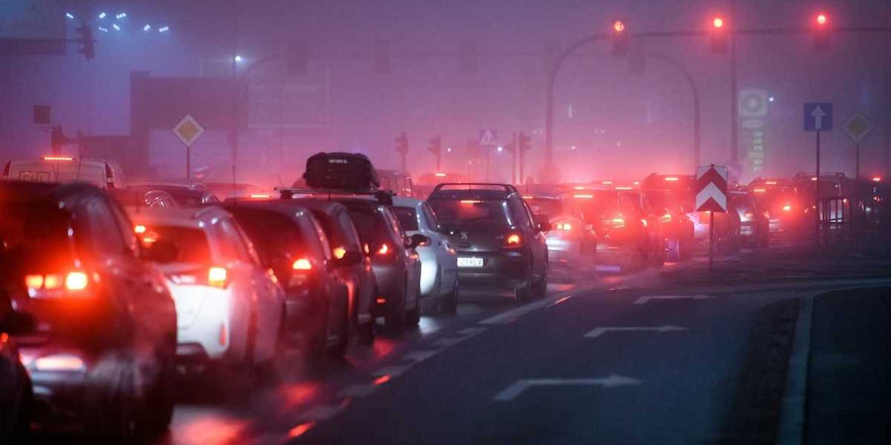 Traffic lined up at stoplight, idling and polluting