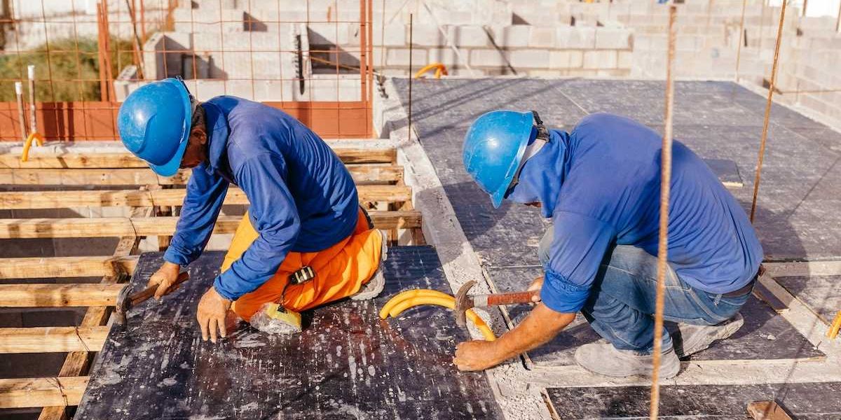 Two construction workers on a hot roof