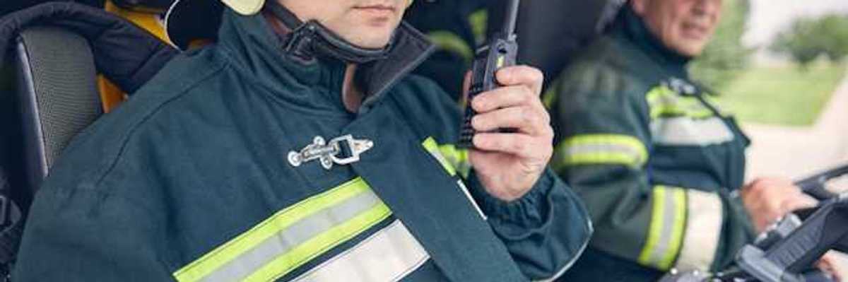 Two firemen sitting in a vehicle