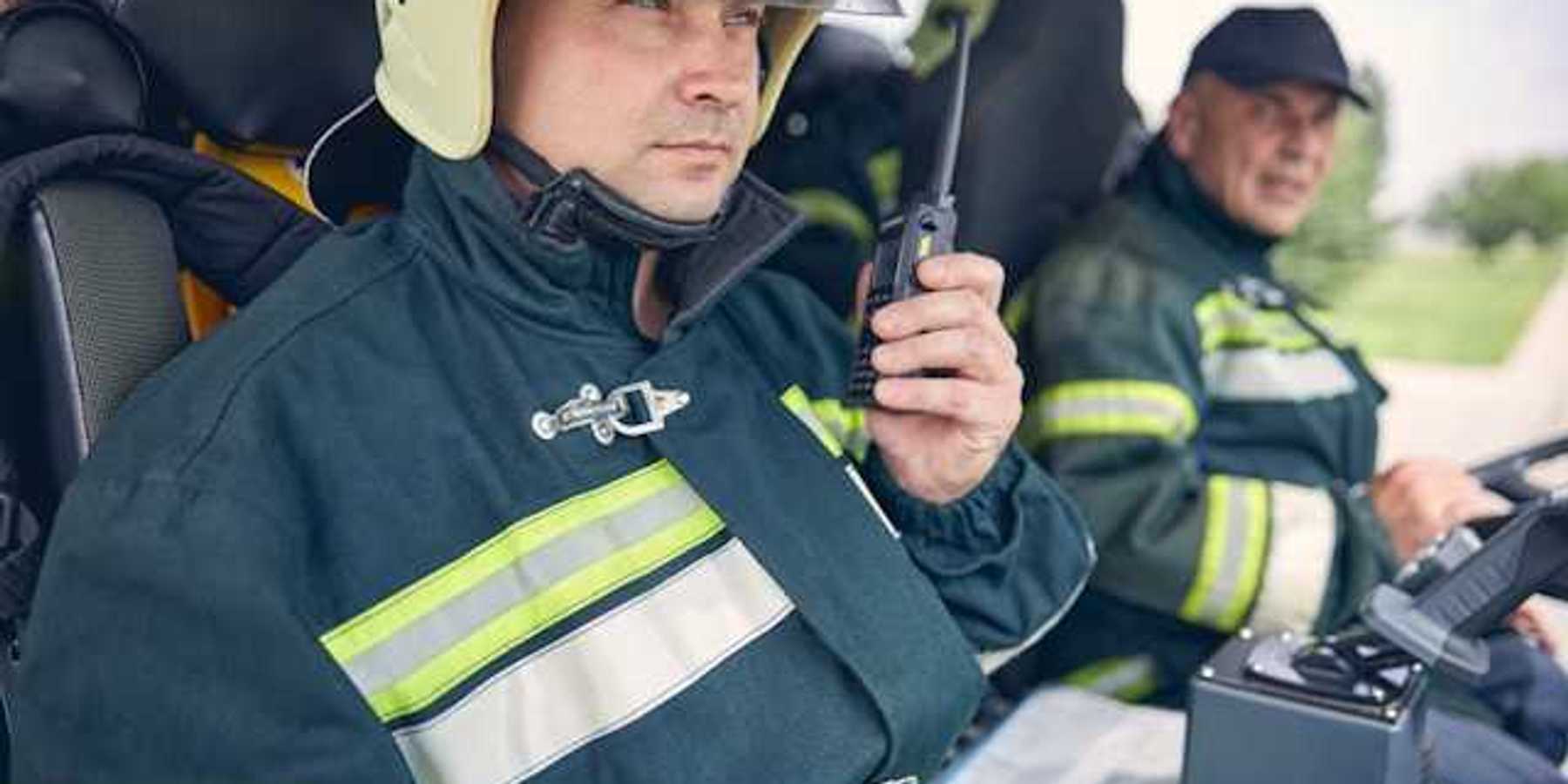Two firemen sitting in a vehicle