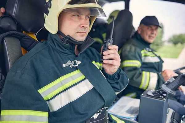 Two firemen sitting in a vehicle