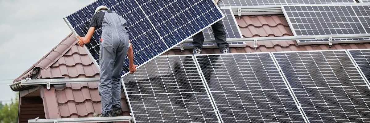 Two men installing residential solar panels