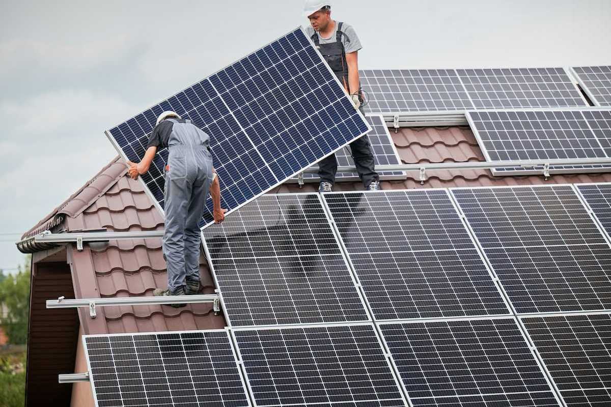 Two men installing residential solar panels