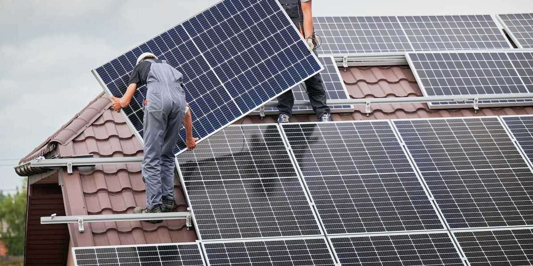Two men installing residential solar panels