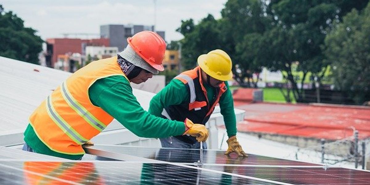 Two men working on a solar panel install