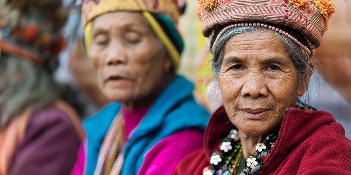 Two senior Filipino women wearing traditional clothing