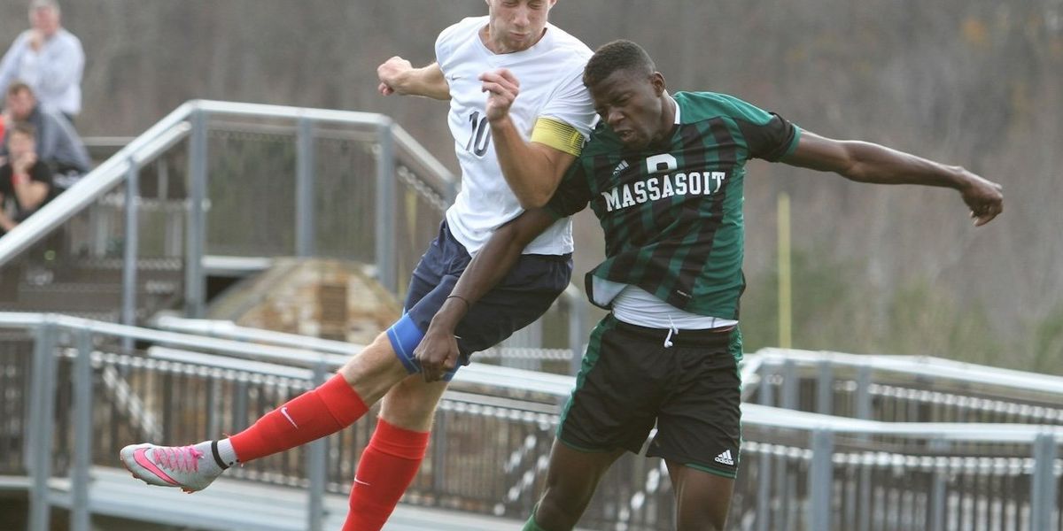 Two soccer players collide mid-air as the ball bounces off one of their heads.