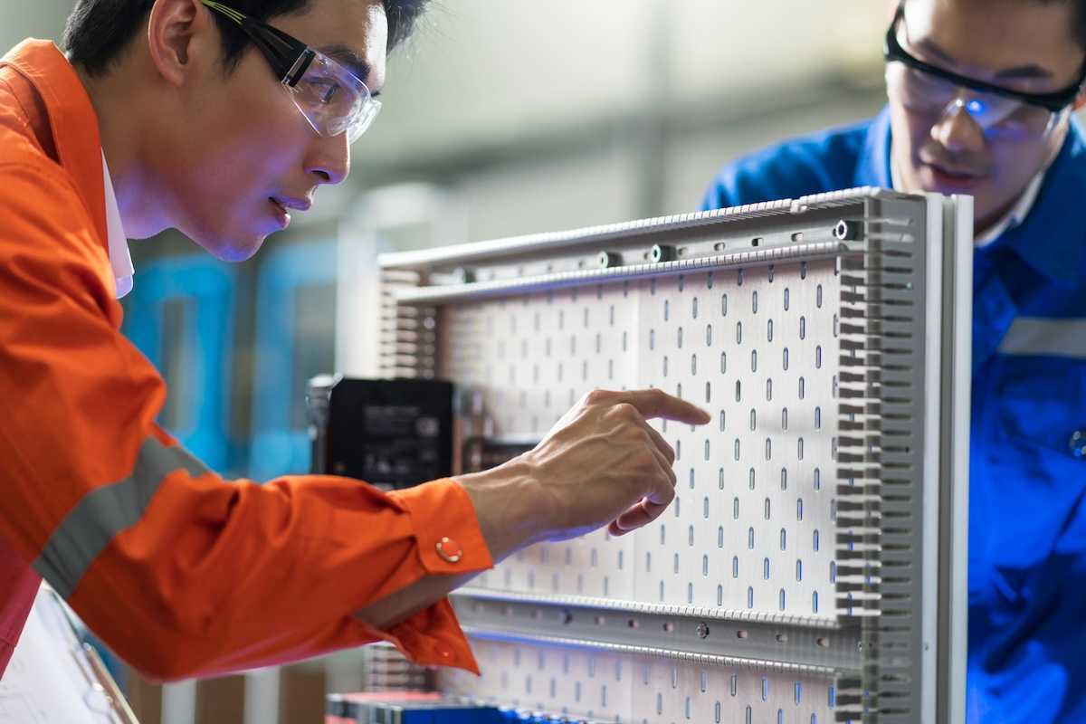 Two technicians working on electrical circuit design