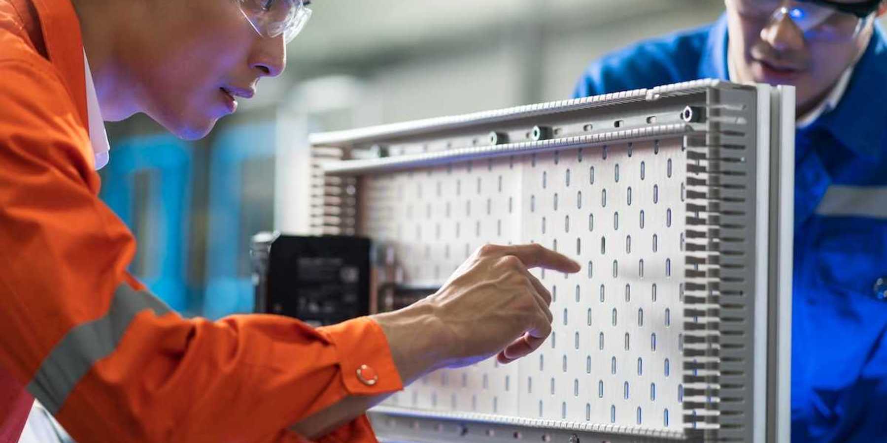Two technicians working on electrical circuit design