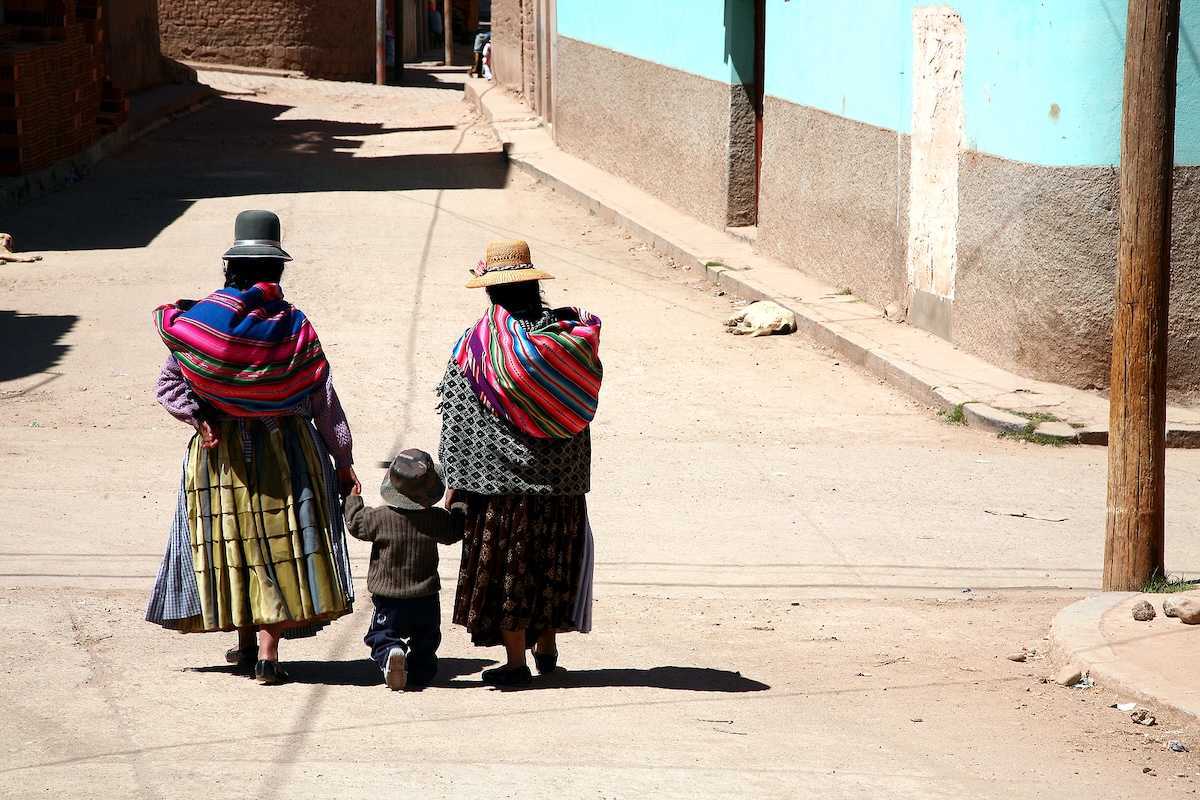 Two women and kid in a street of Copacabana Bolivia