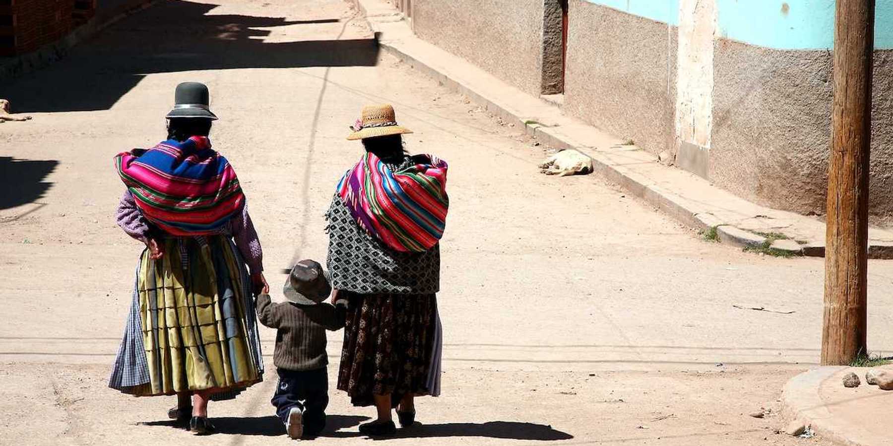 Two women and kid in a street of Copacabana Bolivia