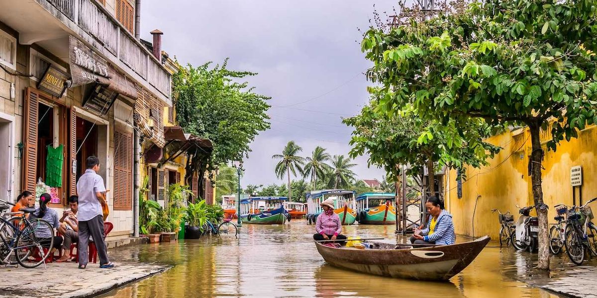 Two women in a boat on a flooded street in Vietnam