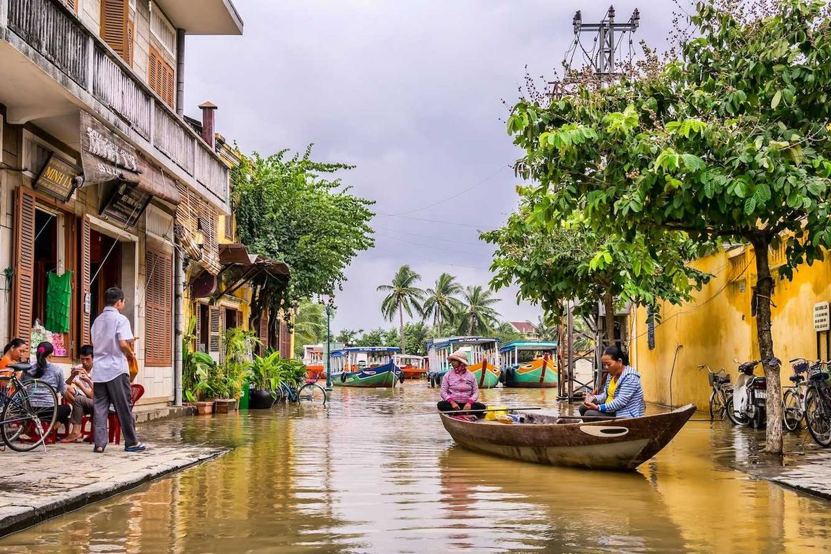 Two women in a boat on a flooded street in Vietnam