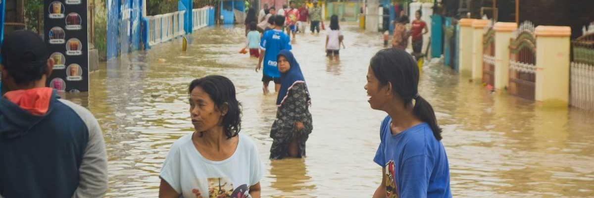 Typhoon victims wade through floodwaters in storm aftermath