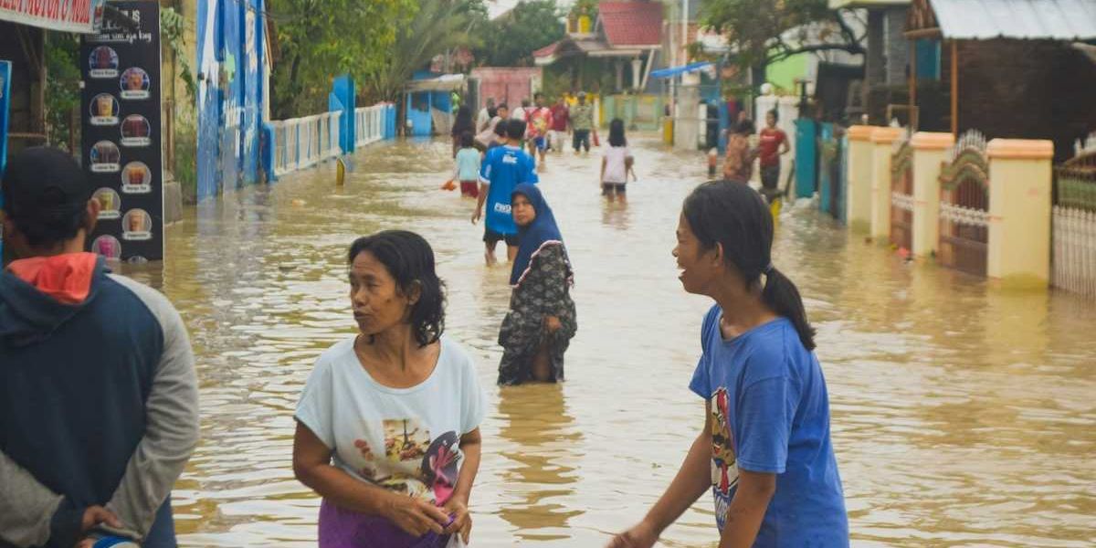 Typhoon victims wade through floodwaters in storm aftermath