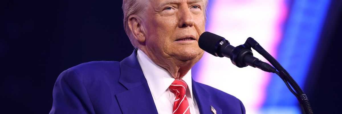 U.S. president Donald Trump speaking into microphone