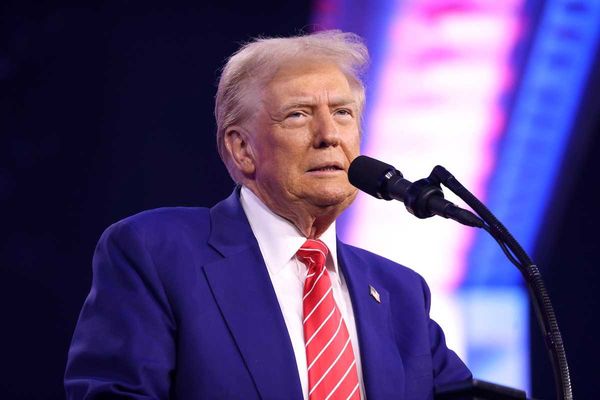 U.S. president Donald Trump speaking into microphone