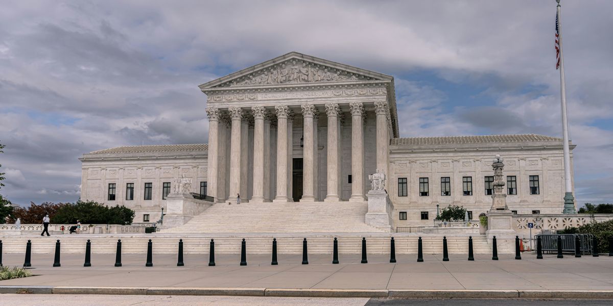 U.S. Supreme Court building under white clouds during daytime.