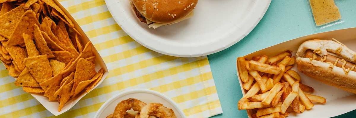 Ultra-processed food: Tortilla chips, fried onion rings, french fries, cheese burgers, and hot dog.