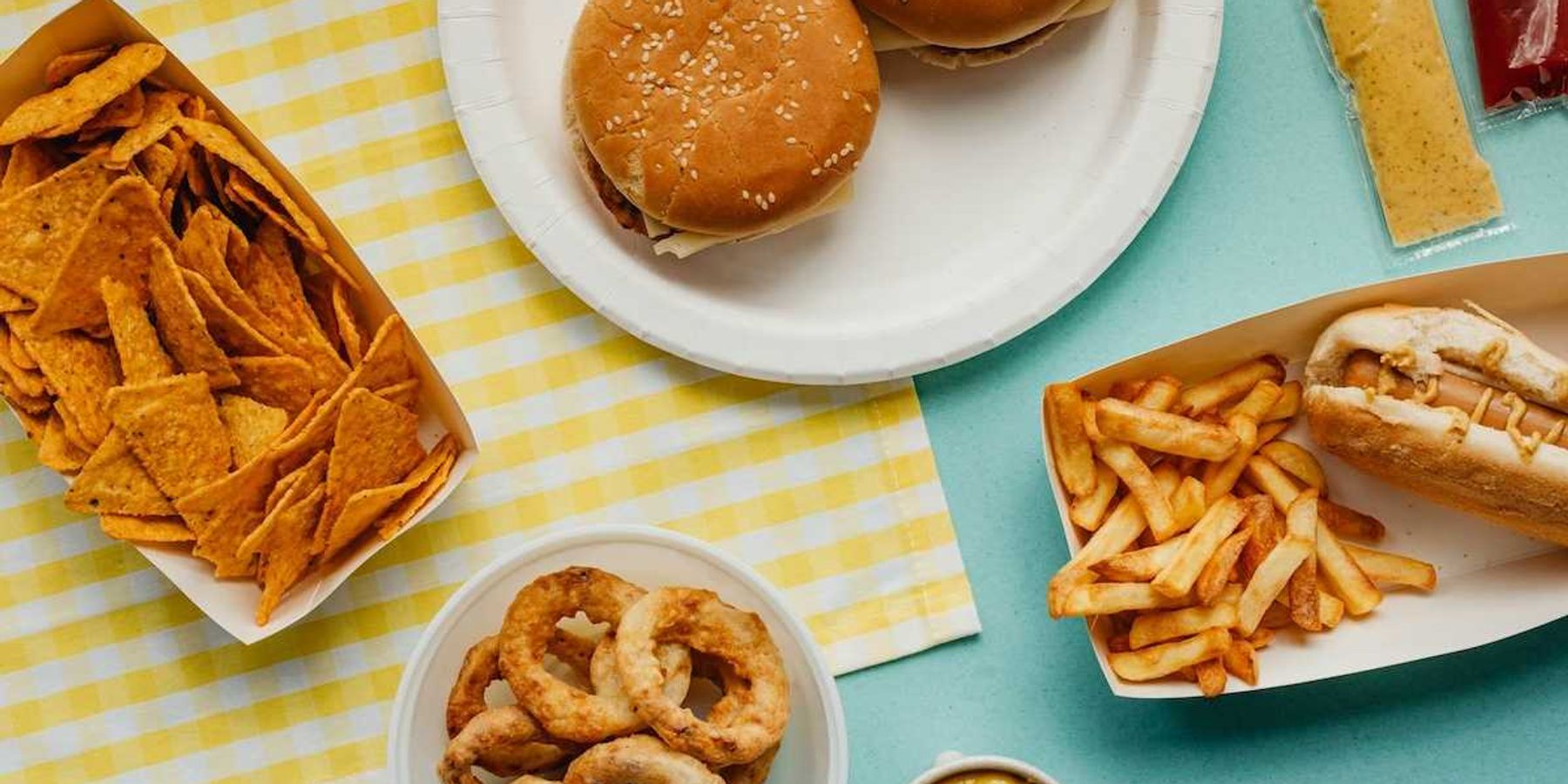 Ultra-processed food: Tortilla chips, fried onion rings, french fries, cheese burgers, and hot dog.
