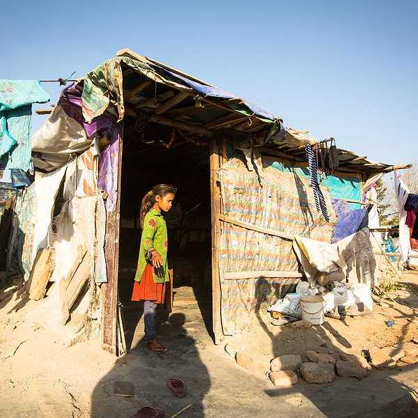 Unidentified poor people near their houses at slums in Tripureshwor district, Kathmandu.