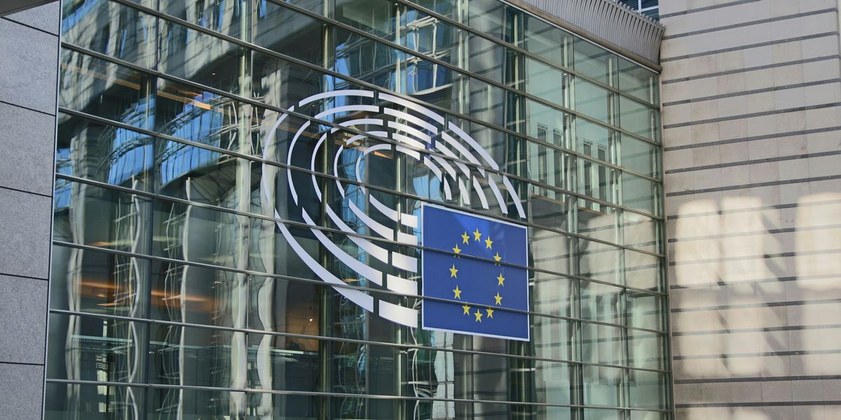 United Nations parliament building with glass wall and the EU flag