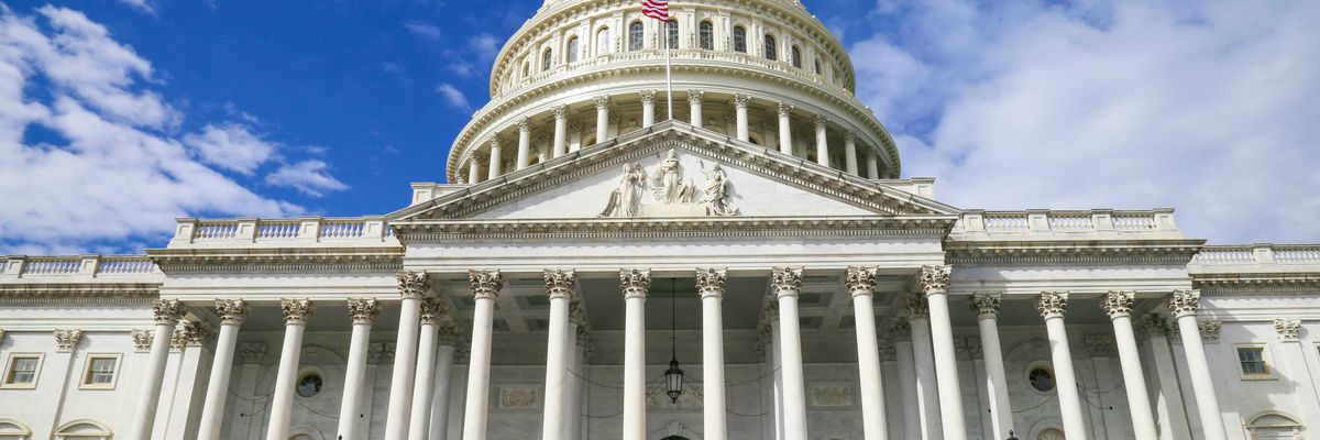 US capitol building against blue sky.