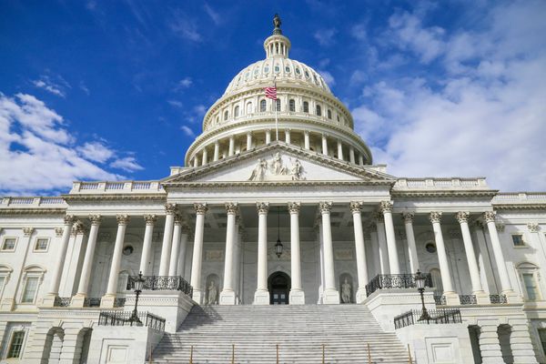 US capitol building against blue sky.