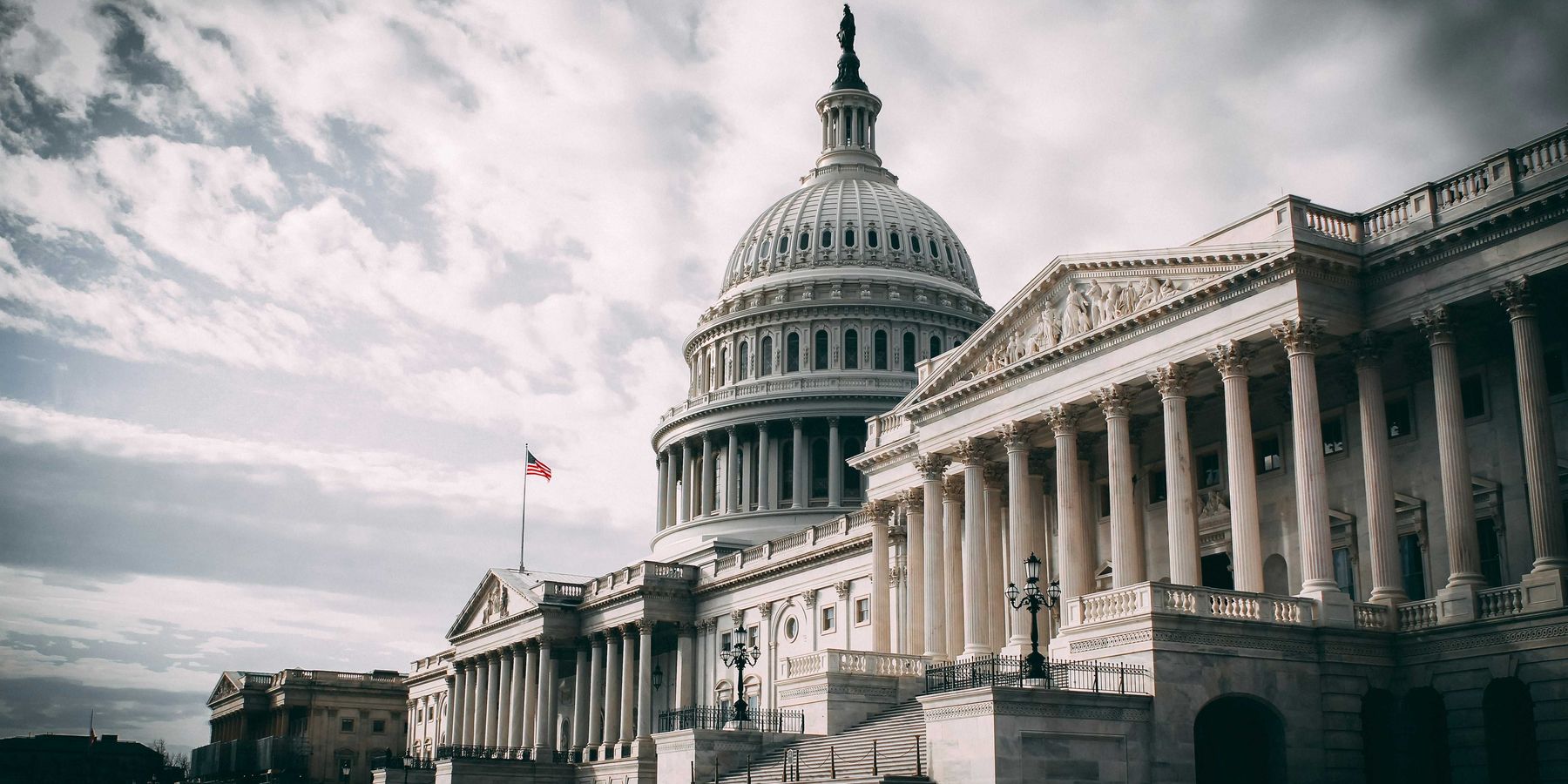 US Capitol under cloudy sky during daytime.