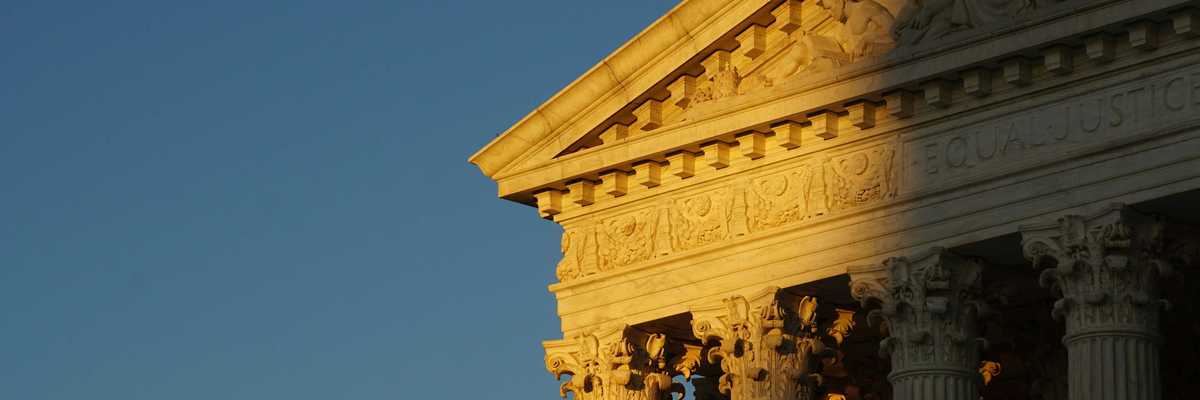 US Supreme Court roof and pillars in evening sun and shadow.