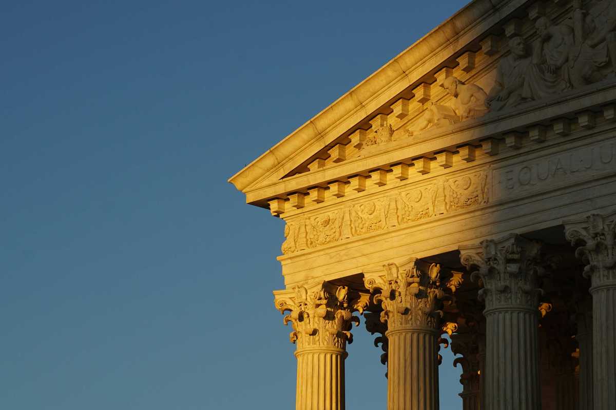 US Supreme Court roof and pillars in evening sun and shadow.