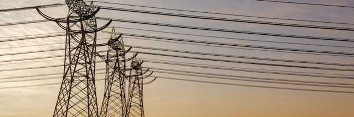 Utility lines stretching into the distance at sunset