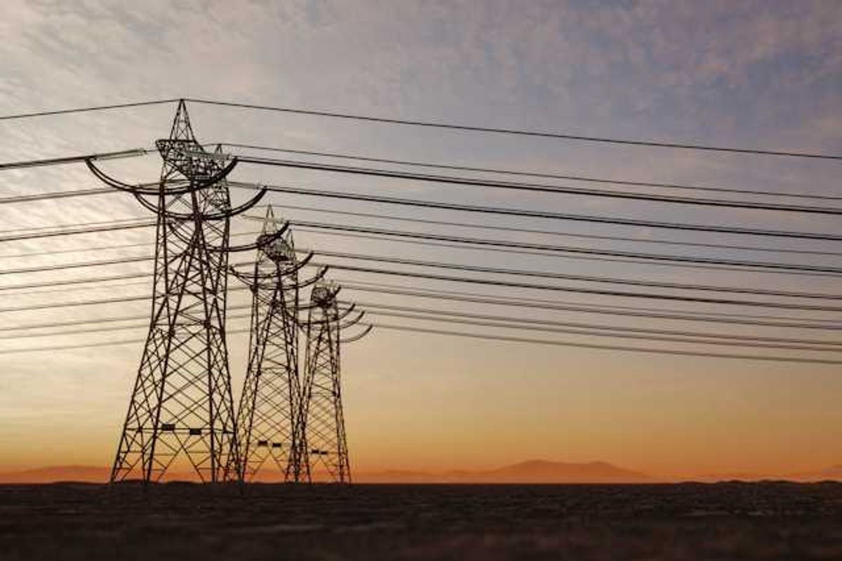 Utility lines stretching into the distance at sunset
