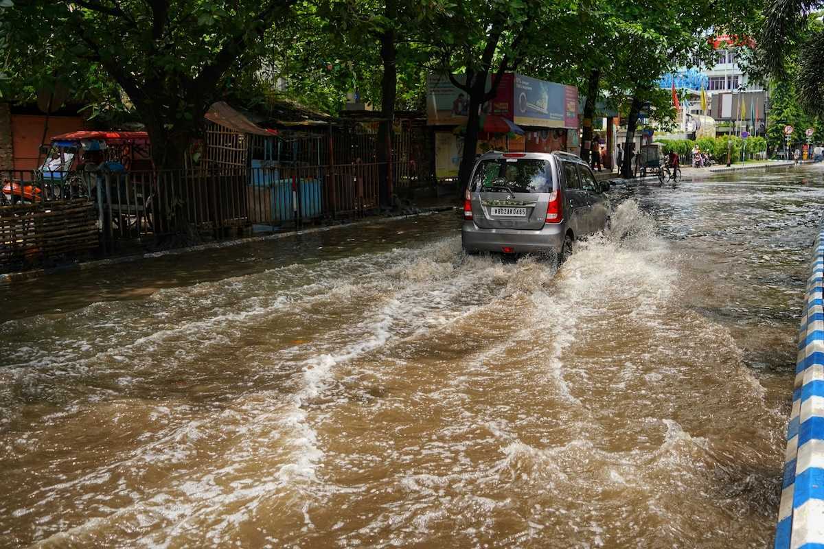 Van traveling on a flooded city street