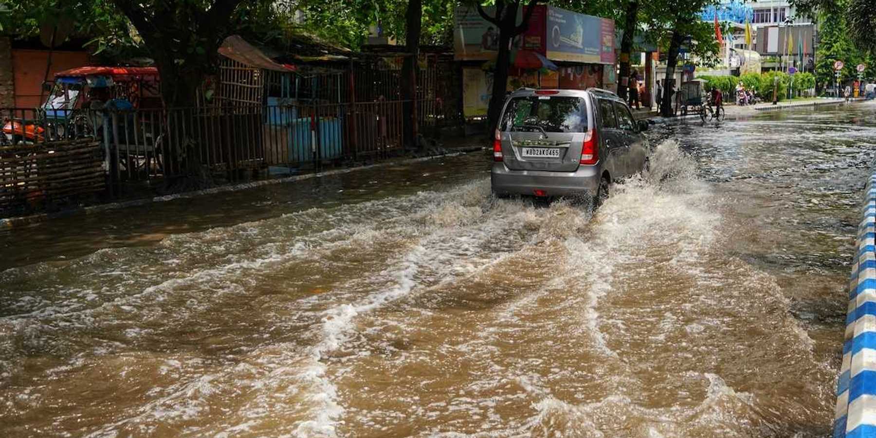 Van traveling on a flooded city street