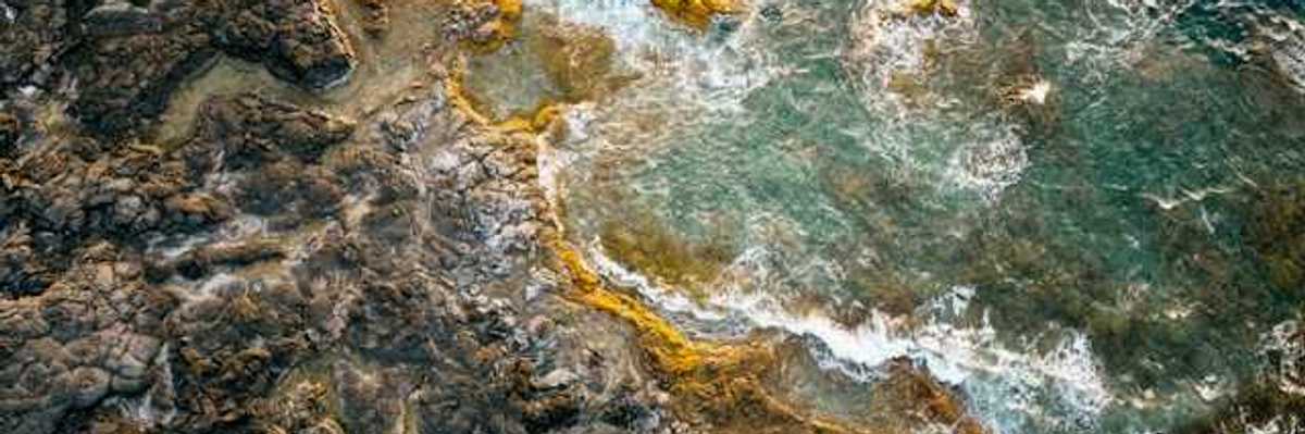 Volcanic rock coastline with ocean waves