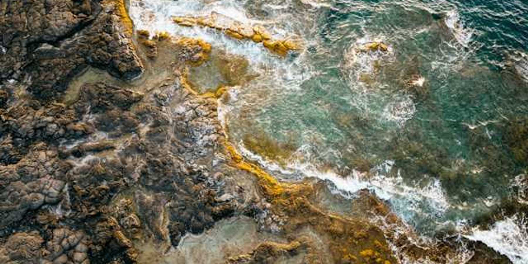 Volcanic rock coastline with ocean waves