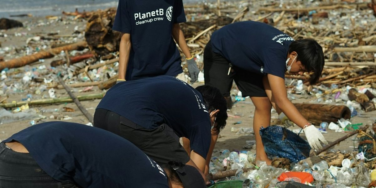 Volunteers recycling plastic beach trash.