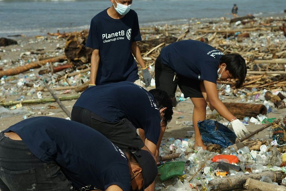 Volunteers recycling plastic beach trash.