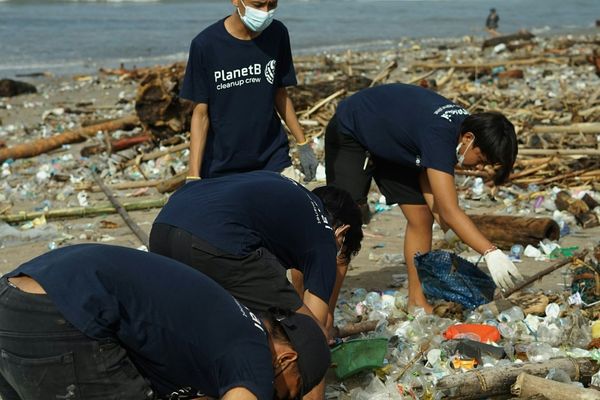Volunteers recycling plastic beach trash.