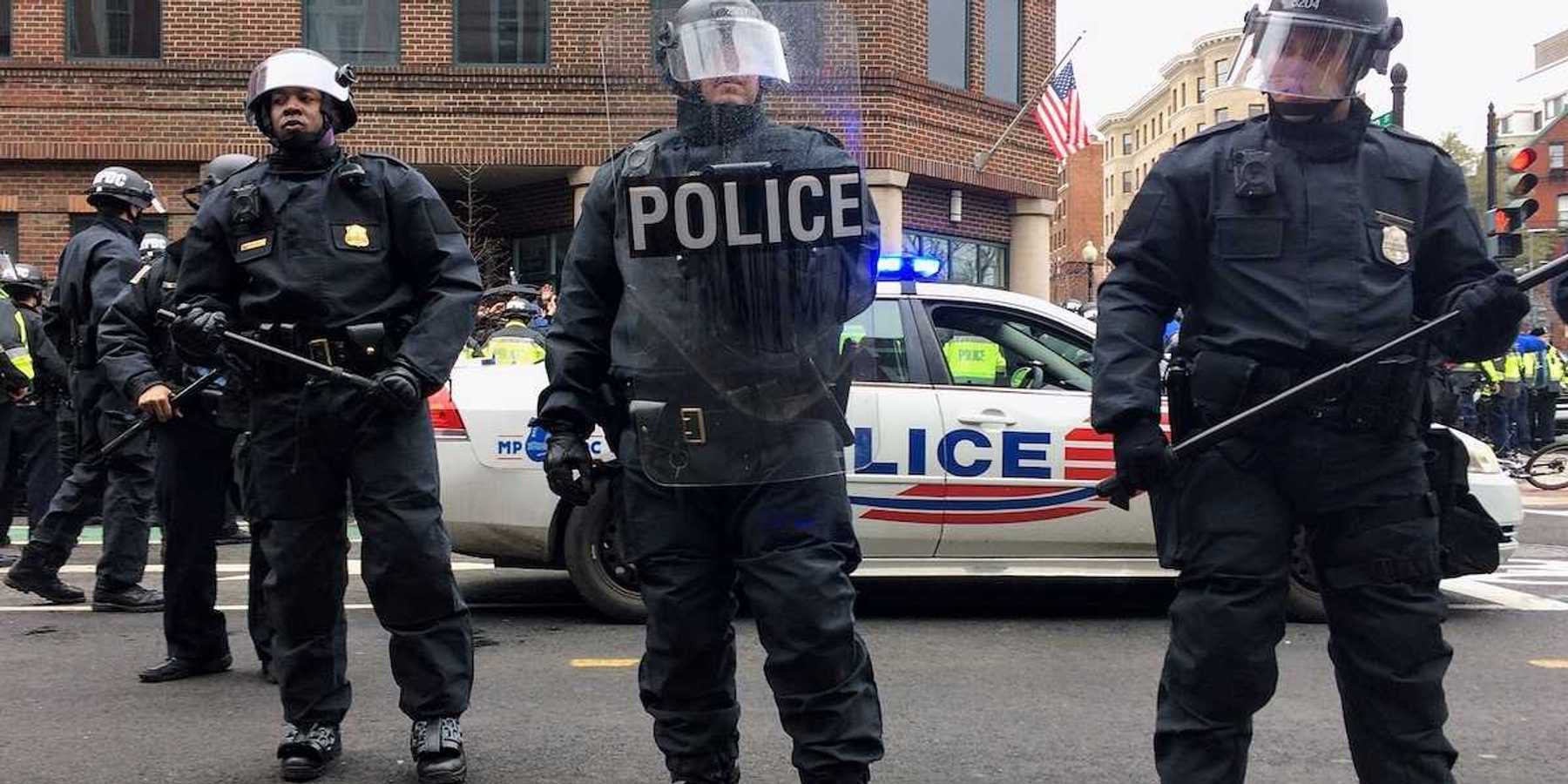 Washington DC police in riot gear brandishing clubs and other riot gear